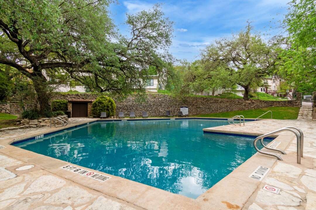 Gated community grounds shaded by mature oaks
