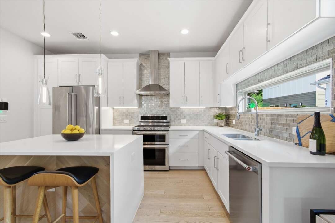 Kitchen detail with white cabinets and stainless appliances