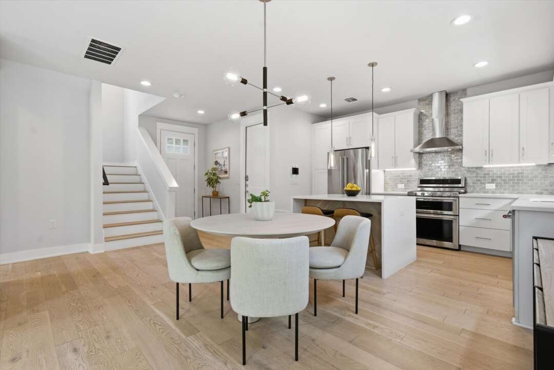 Kitchen opening to dining and staircase