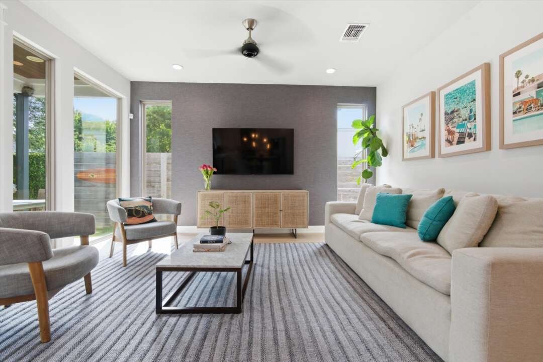 Living room with mounted TV and gray sofa