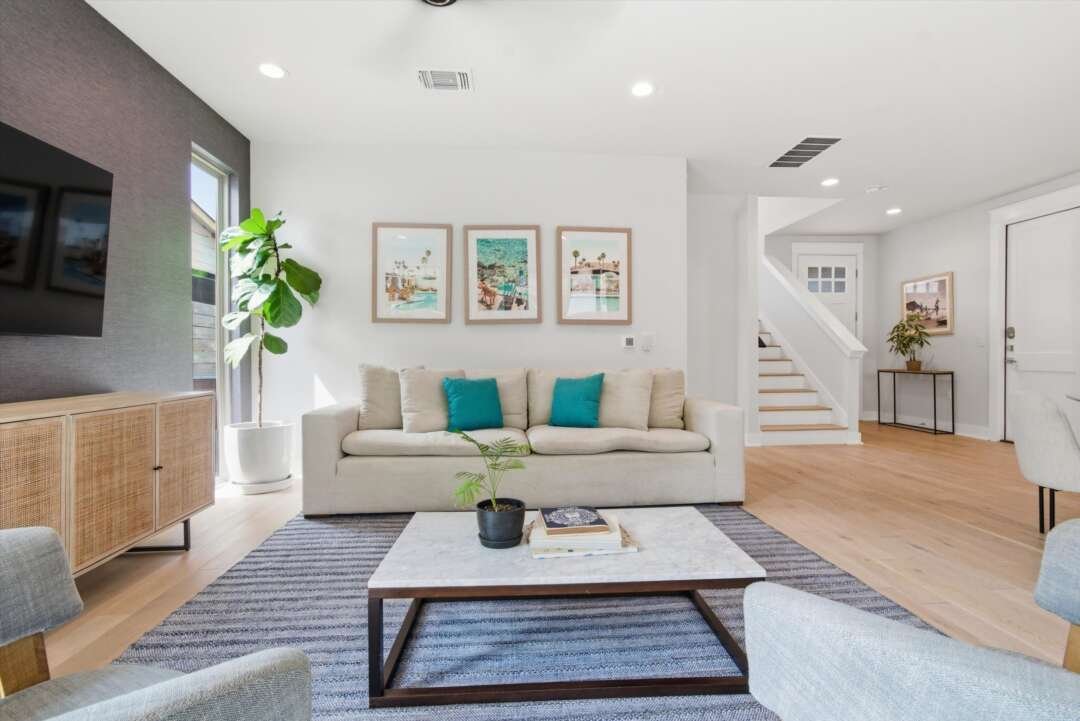 Living room alternate angle with art and white sofa