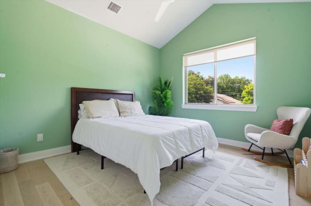 Junior Suite second-floor bedroom at 2710 Zaragosa with green accent wall