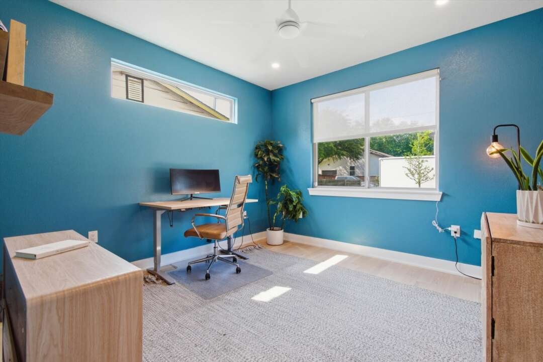 Study Suite first-floor bedroom staged as office with deep blue wall