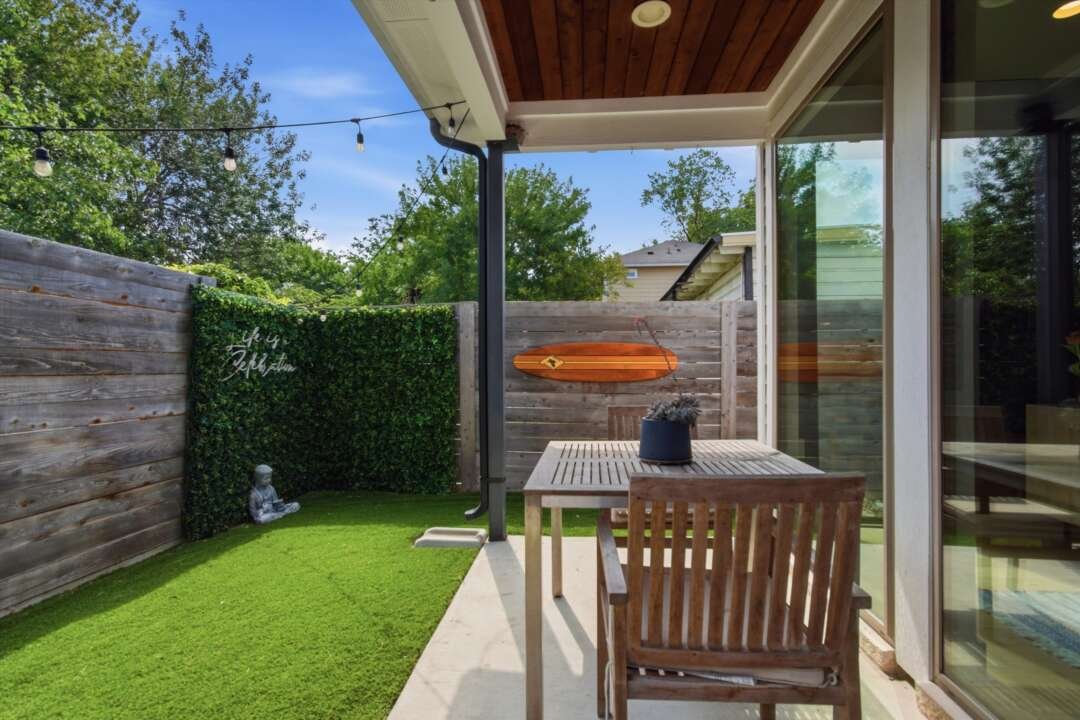 Outdoor lounge area with bench and garden