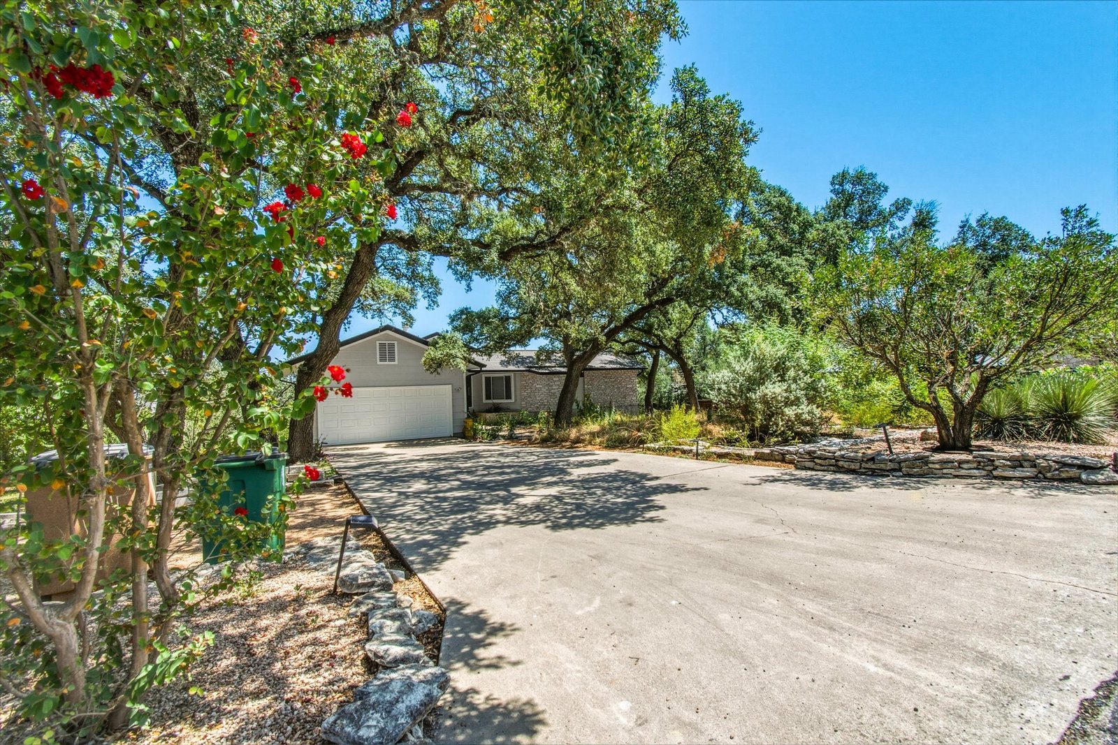Driveway approach and front elevation with crepe myrtle in bloom