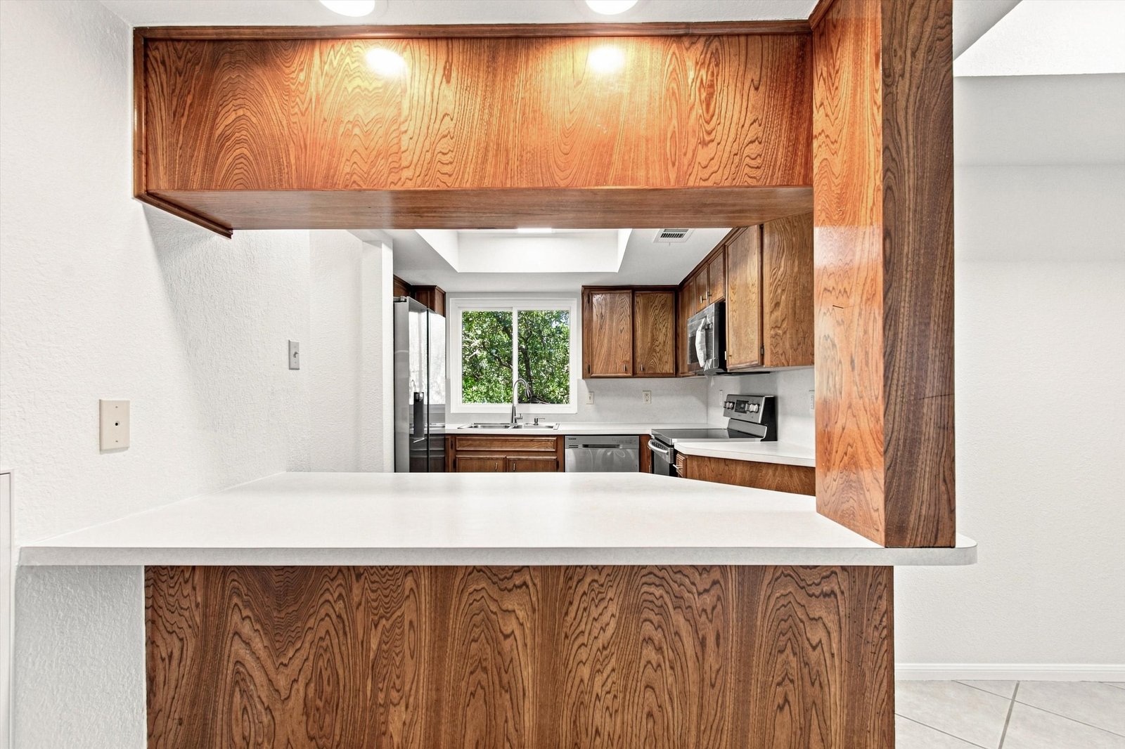Kitchen peninsula with pass-through and view into the kitchen