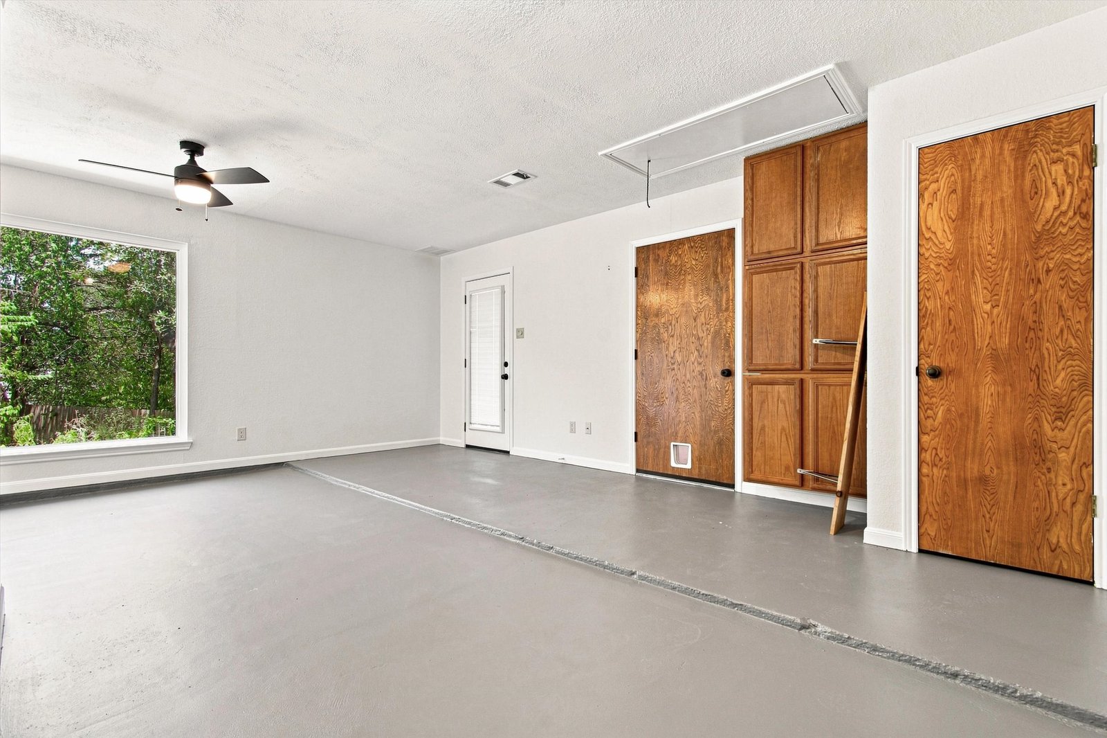 Bonus room with built-in wood cabinets and exterior door